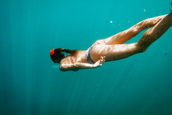 Luxury Snorkeling Tour in Cabo San Lucas - Sailing past Medano Beach with a drink in hand